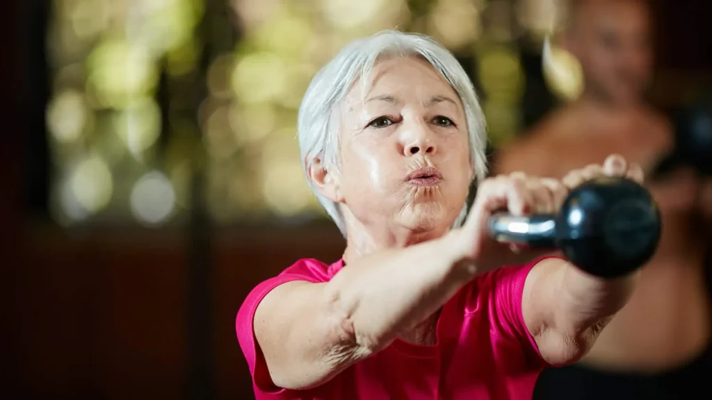 Toning Arms Without the Bulk: Is It Achievable? 1 Woman doing resistance band exercises for toned arms Borehamwood