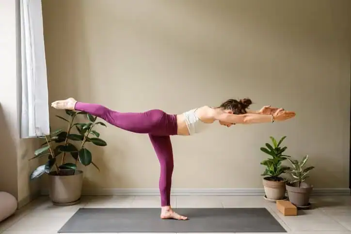 Woman doing Yoga exercise Borehamwood to help with toning the body. 